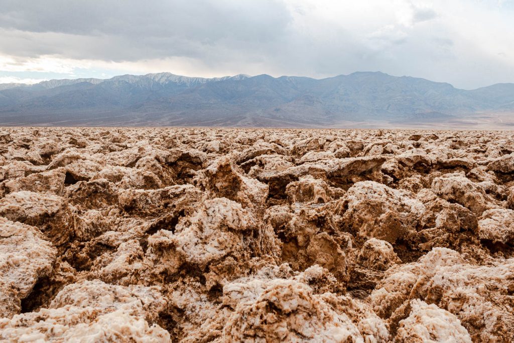 up close view of salt flat with mountains in background