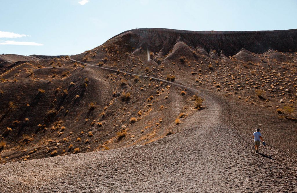 hiker climbing up Ubehebe crater on a Death Valley day tri[