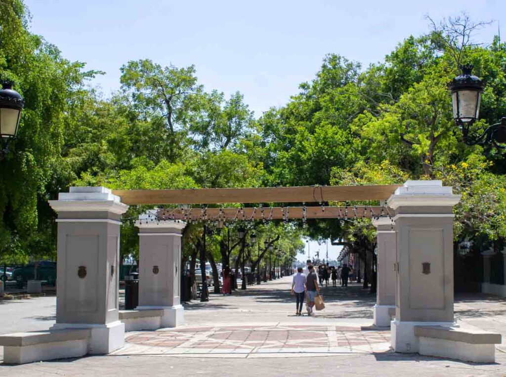 people walking along the Paseo de la Princesa on an old san juan day